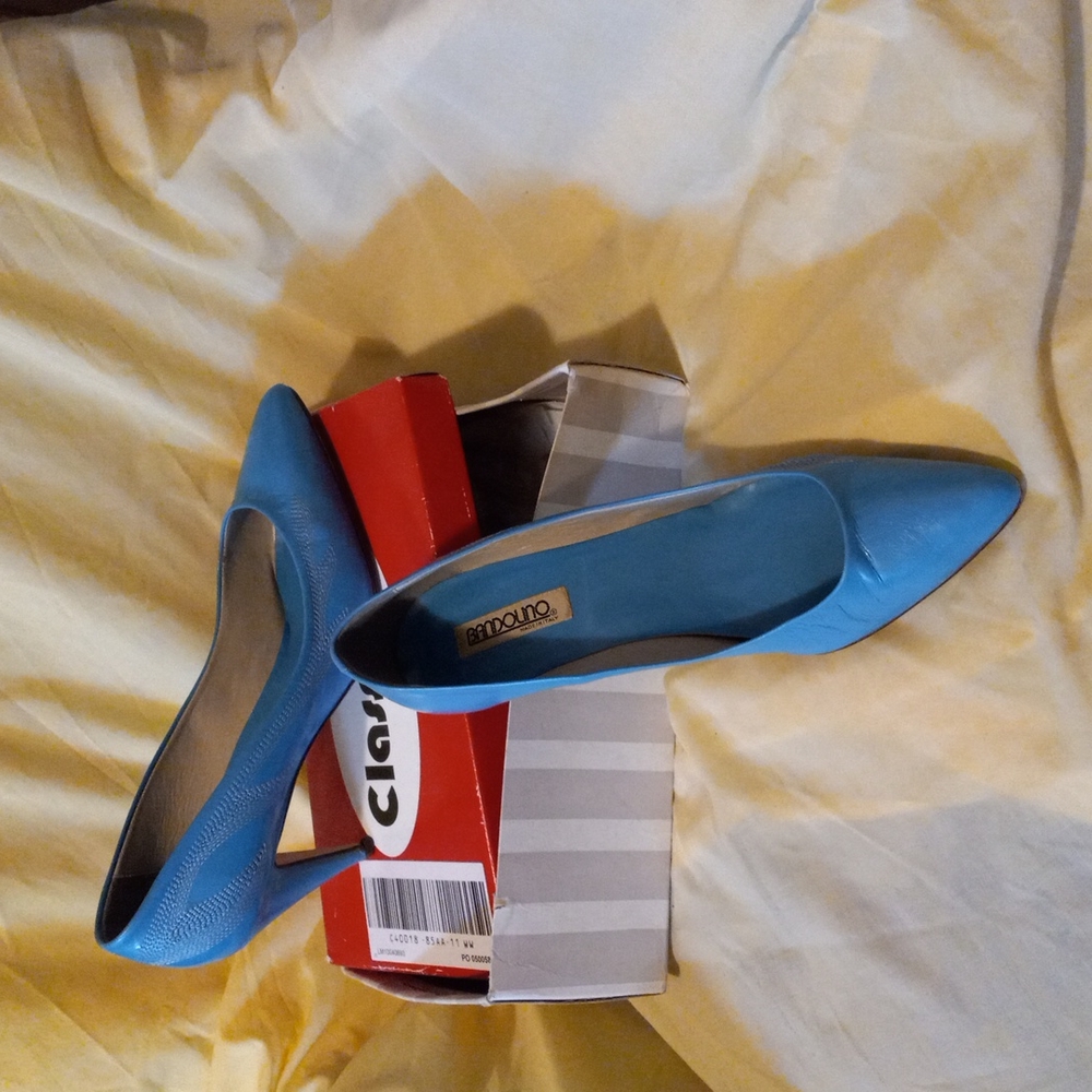 A blue pair of size 12 high heel ladies shoes with silver designs l on the side